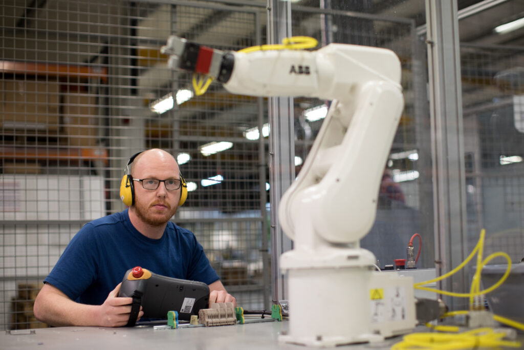 Modular worker reviewing mechanical arm performance